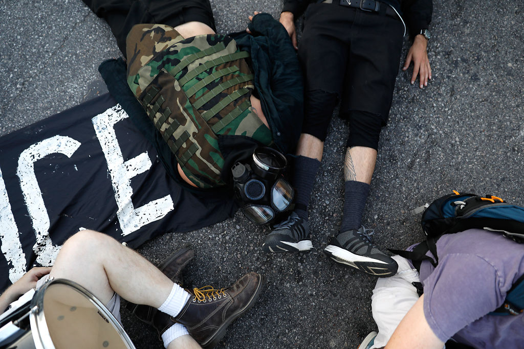 Demonstrators participate in a "die-in"